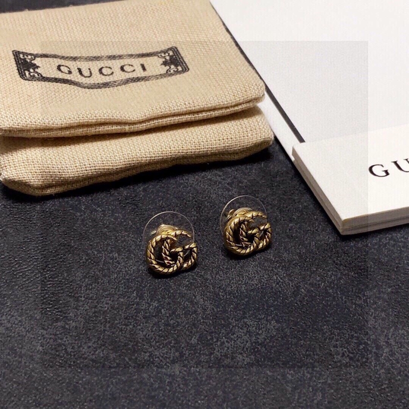 G*u*i earrings